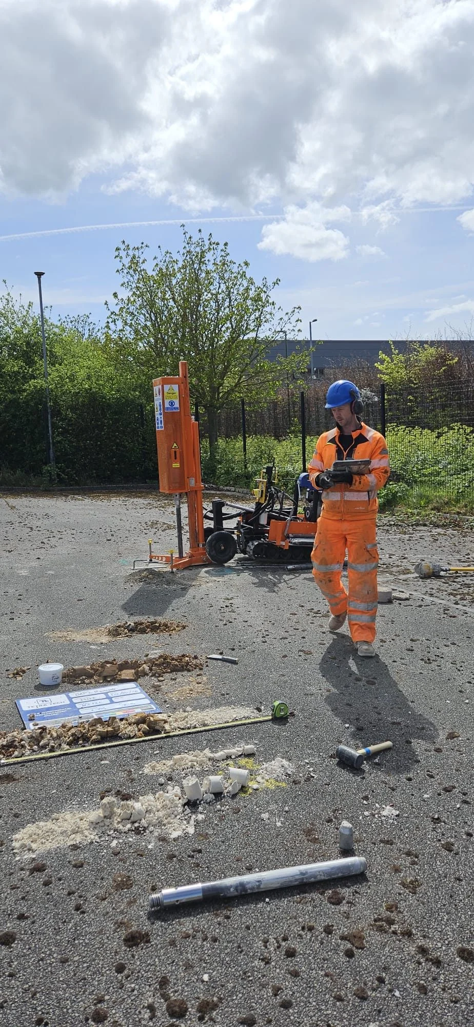 Operator logging recovered chalk samples on a tablet beside the window sample rig.