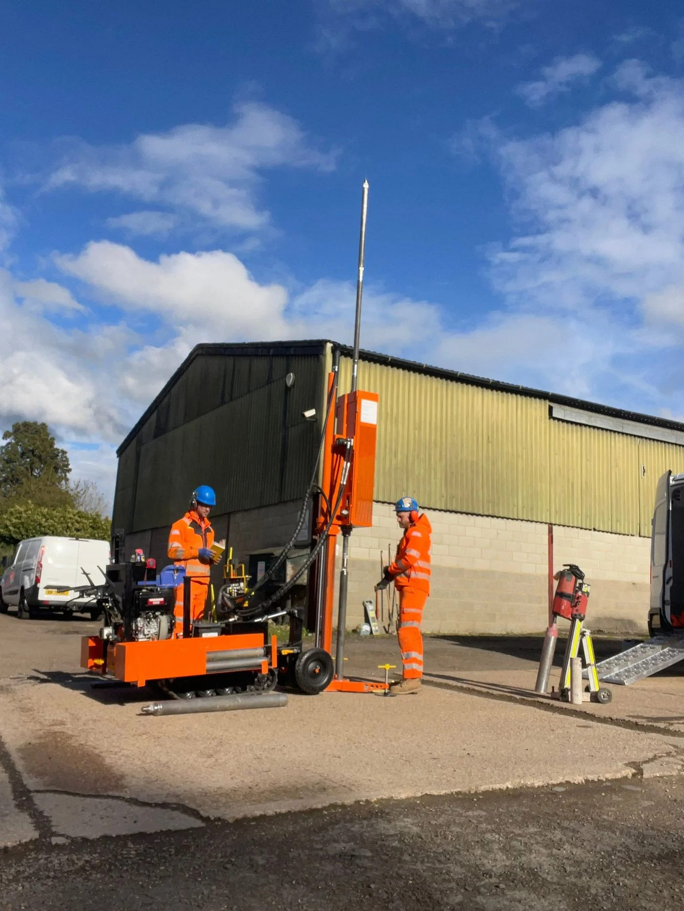 Two Strata Geotech operators setting up the window sample rig at a commercial site.